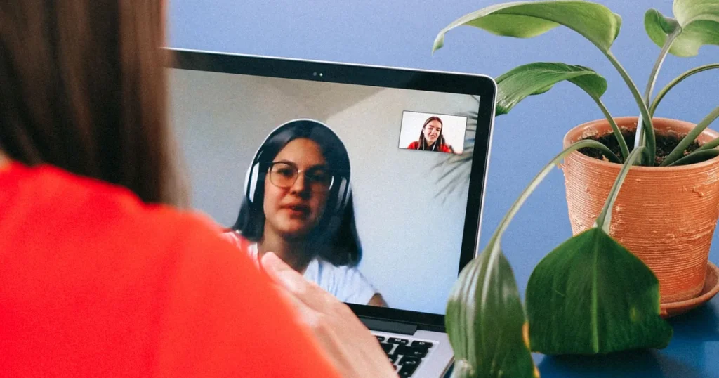 Mulher em consulta online por videochamada com nutricionista, notebook sobre mesa